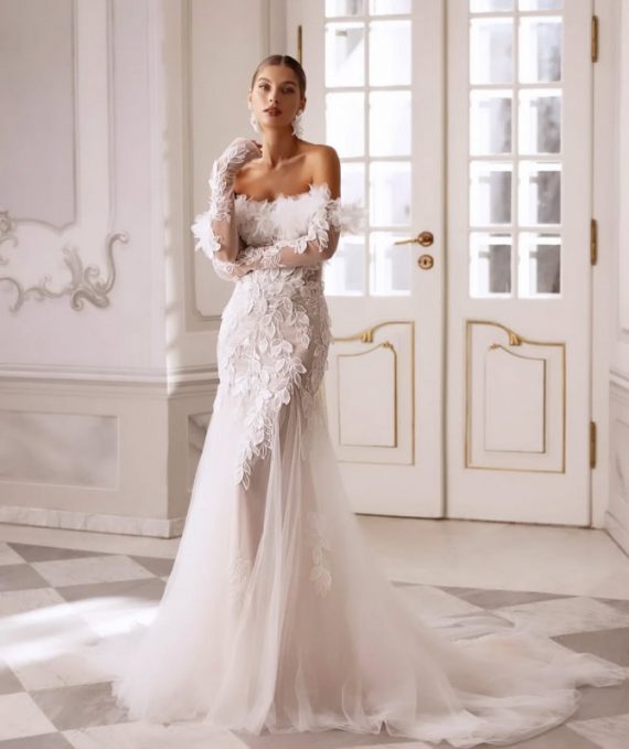 : Bride in feather off-shoulder wedding gown with lace bodice and long tulle train