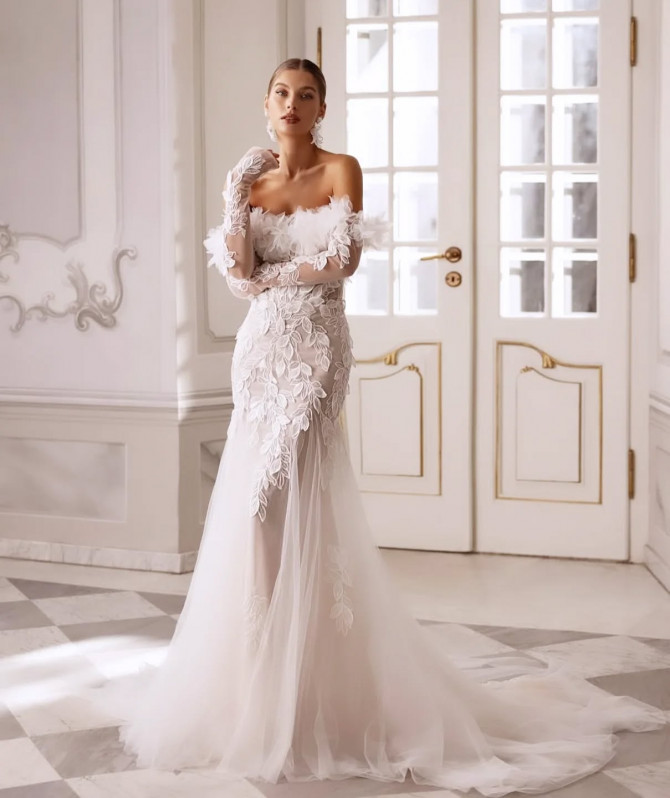 : Bride in feather off-shoulder wedding gown with lace bodice and long tulle train
