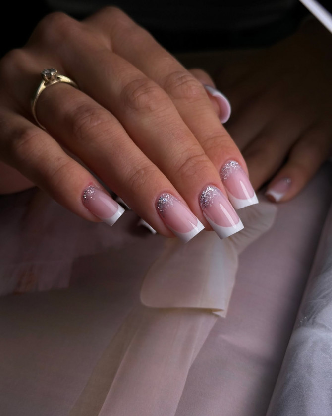 Square-shaped French bridal nails with a soft nude base and sparkling silver glitter at the cuticles—perfect for a chic and refined wedding look.