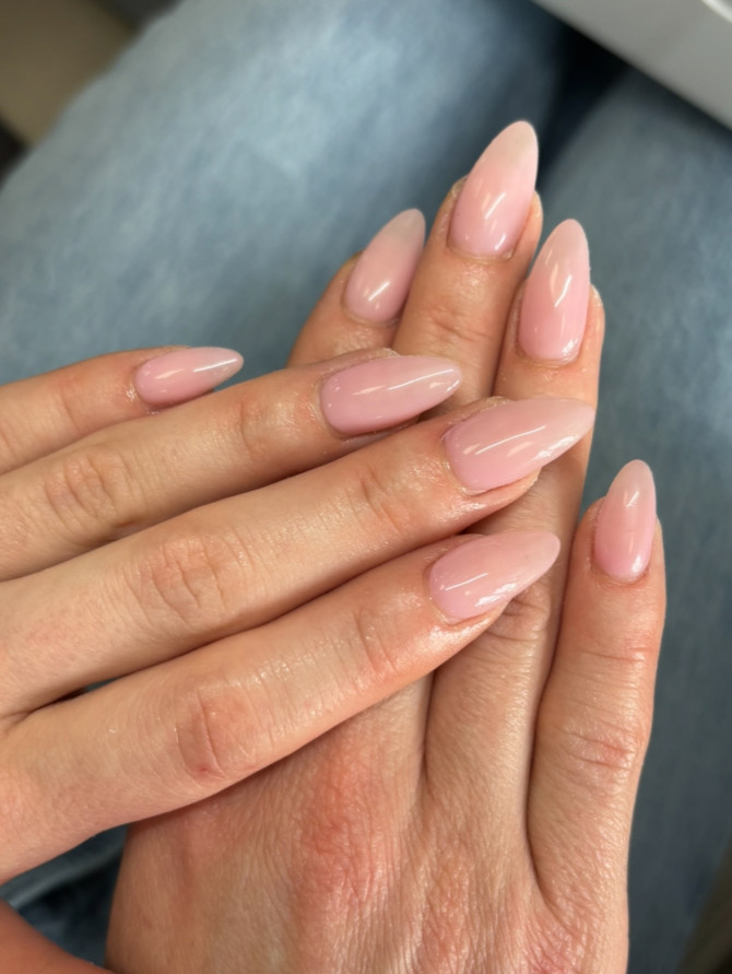 Natural almond-shaped nails in a glossy blush pink shade, offering a timeless and effortless look for any bride.