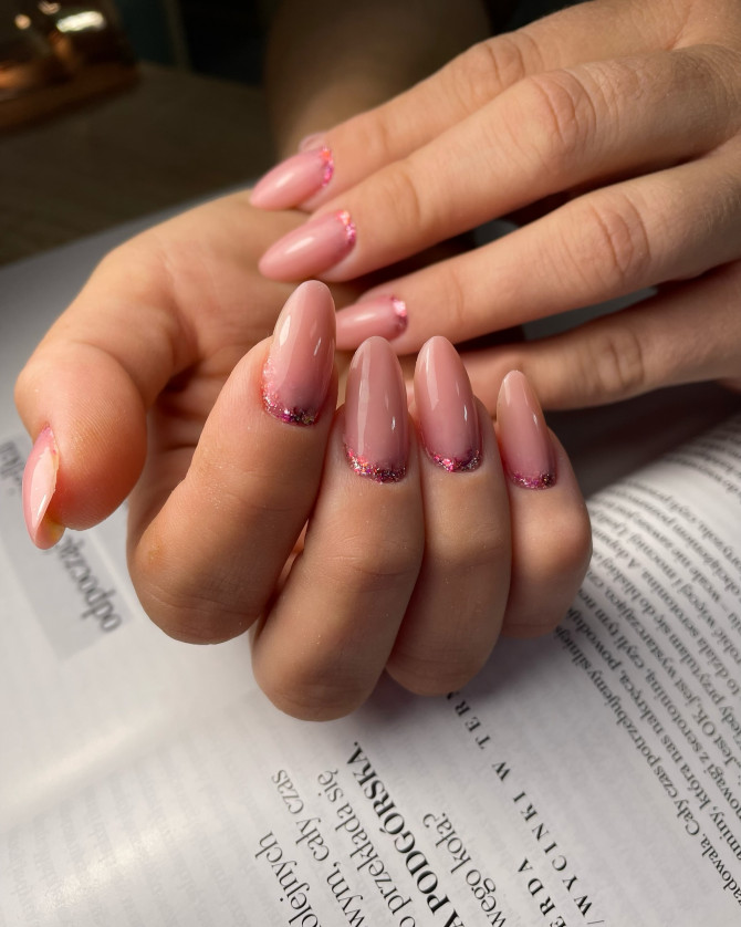 Almond-shaped bridal nails in a glossy rose pink tone with sparkling pink glitter at the cuticles—ideal for brides who love a hint of glamour and femininity.