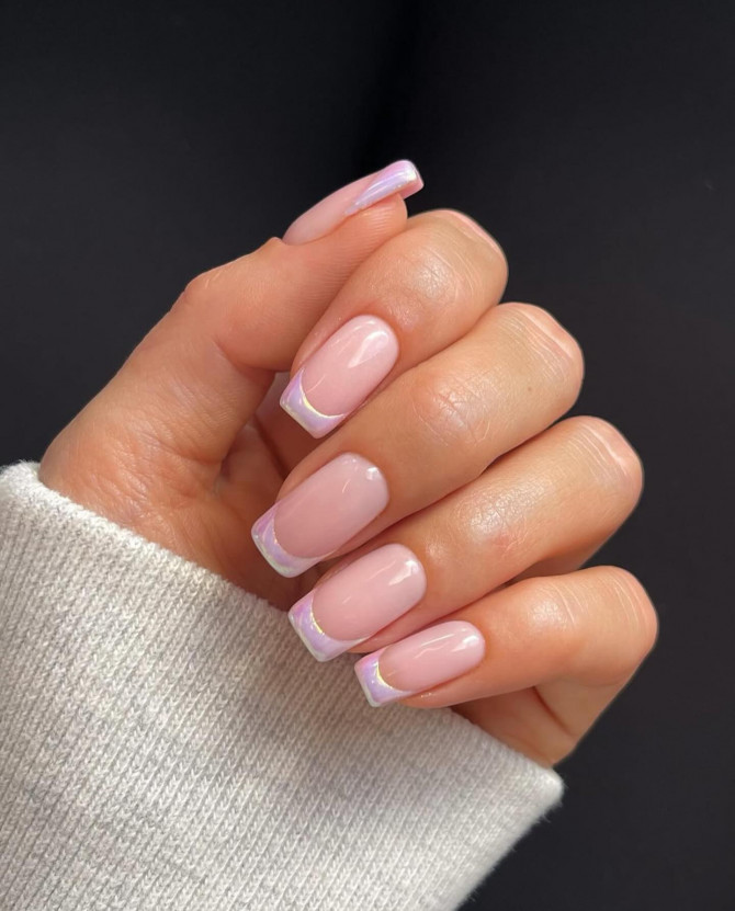 Glossy nude nails with soft pink chrome French tips and a subtle iridescent sheen, ideal for a modern and stylish bridal manicure.