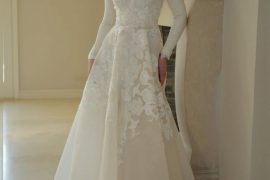 Elegant lace appliqué long-sleeve bridal gown by Zehavi Pick, featuring a high neckline and soft ivory silhouette.