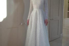 Elegant long-sleeve high-neck bridal gown with shimmering details by Zehavi Pick Bridal.