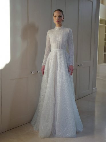 Elegant long-sleeve high-neck bridal gown with shimmering details by Zehavi Pick Bridal.