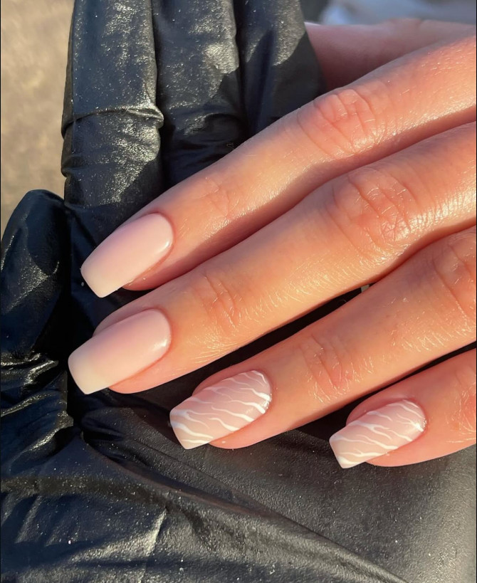 Minimal matte nude nails with soft square tips and subtle white wavy texture accents—ideal for a modern, understated bridal look. Elegant bridal nail designs with nude tones