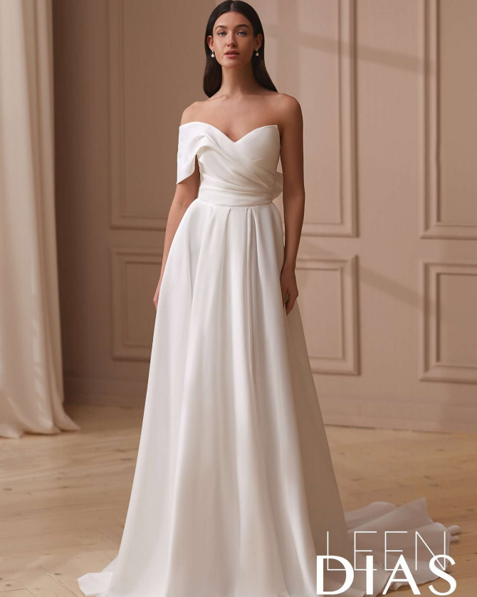Bride in sheer neckline gown with flower appliqué