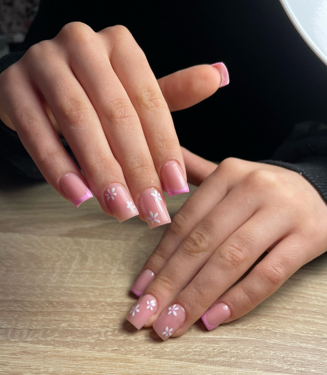 Square nude pink bridal nails with light pink French tips and hand-painted white daisy flowers—perfect for a spring wedding or garden-themed bride.