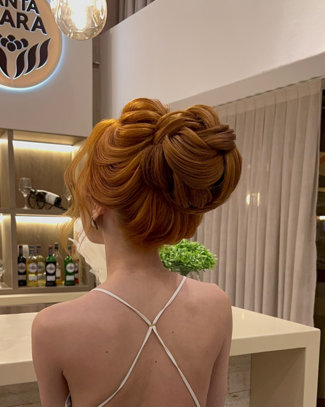 Sculpted High Bun with Dimensional Swirls bridal hairstyle