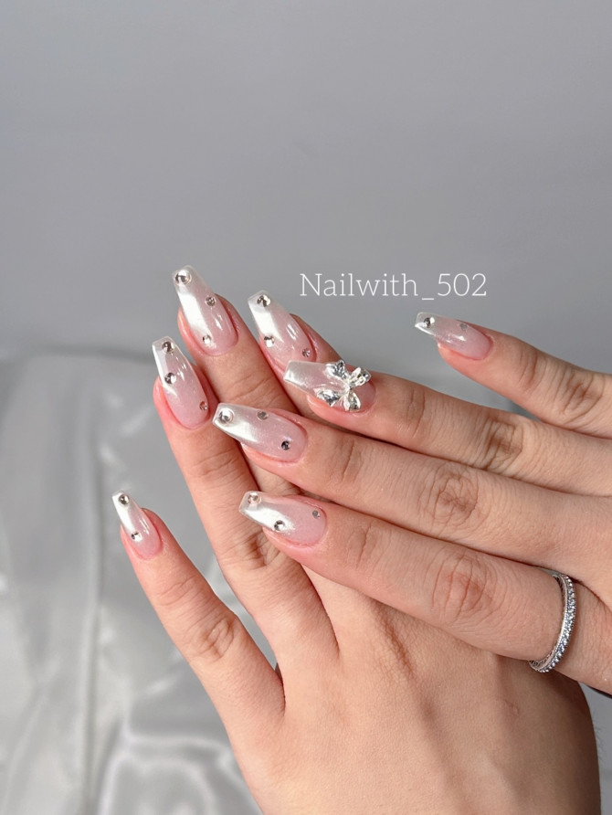 Shimmery silver chrome bridal nails with rhinestones and butterfly accent by @nailwith_502