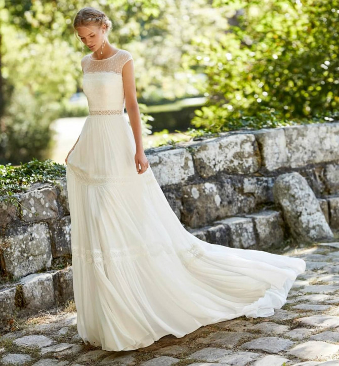 Bride in full lace open-back romantic wedding dress. floral lace dress