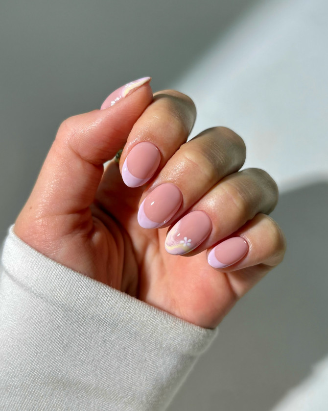 Chic bridal nails featuring soft lilac French tips and a delicate floral accent over a nude base, perfect for a fresh and minimal wedding look. 3D floral bridal nail art for wedding