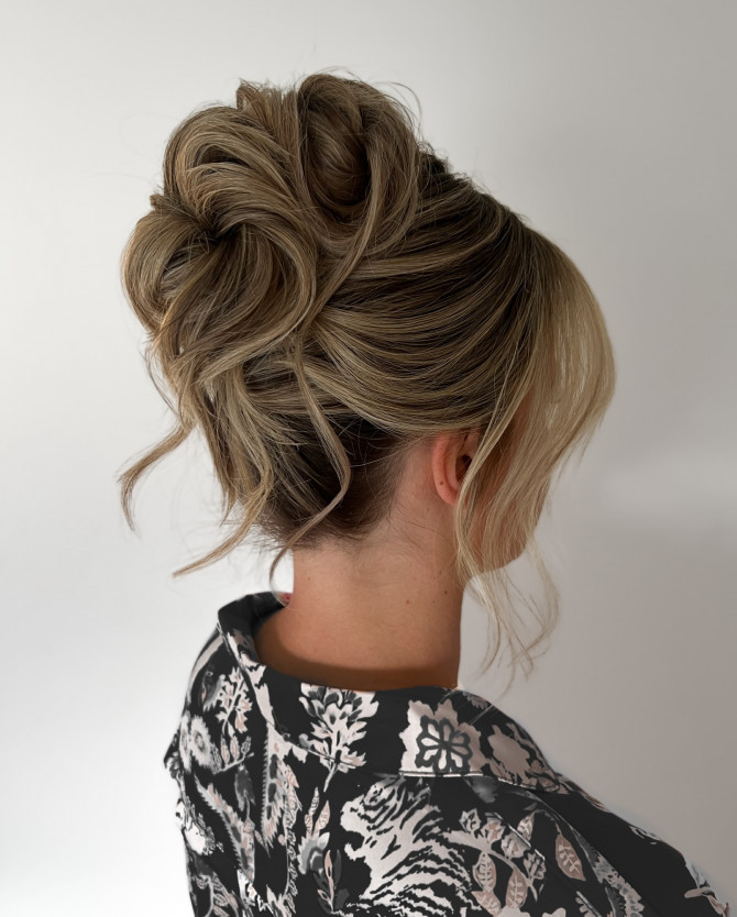 Romantic high sculpted bridal updo with loose tendrils and soft waves by @erikataftbridal