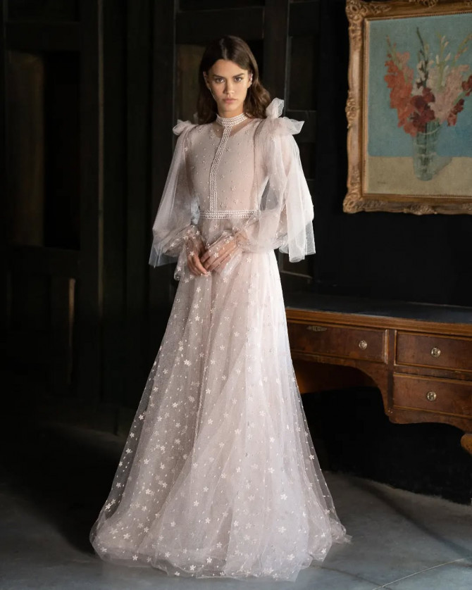 Bride in high-collar lace gown with full-length cape