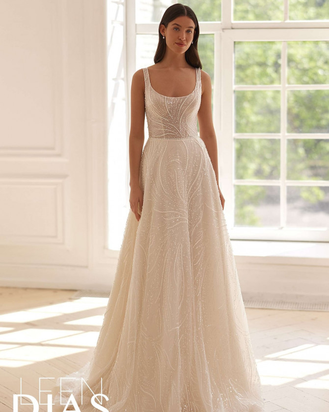 Bride in mesh yoke wedding dress with beaded shoulders