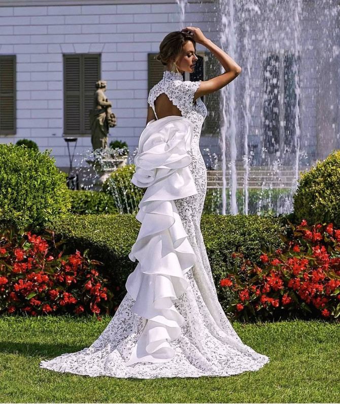 Bride wearing fitted white strappy gown