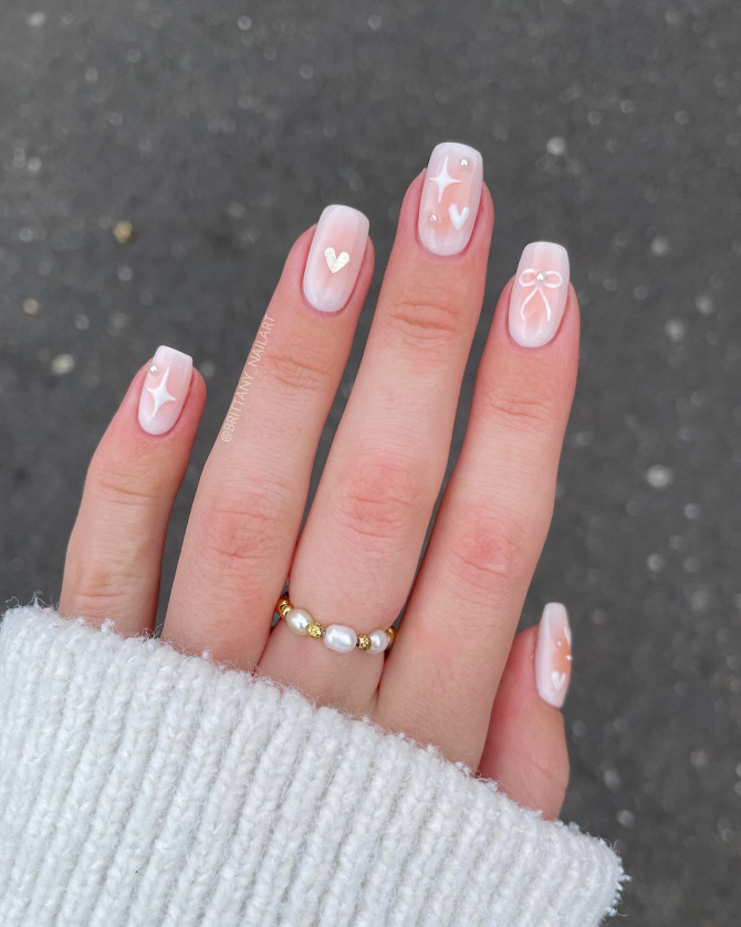 Soft sheer nails with white bow, hearts, and star art