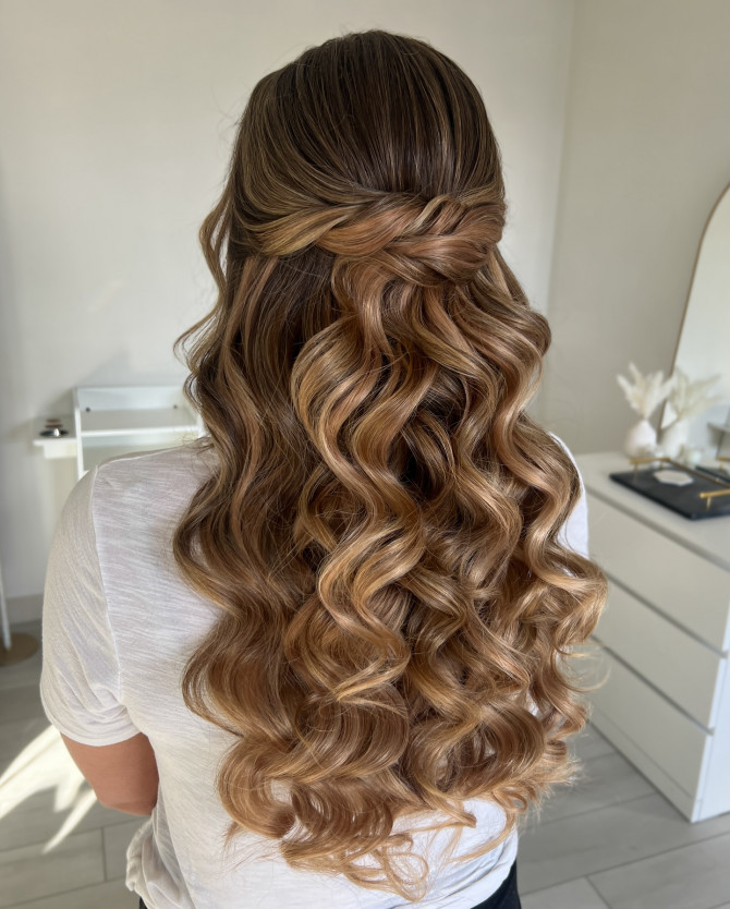 Golden caramel half-up bridal hairstyle with twisted crown and voluminous curls by @erikataftbridal. Romantic bridal hairstyle with caramel curls and twisted crown”