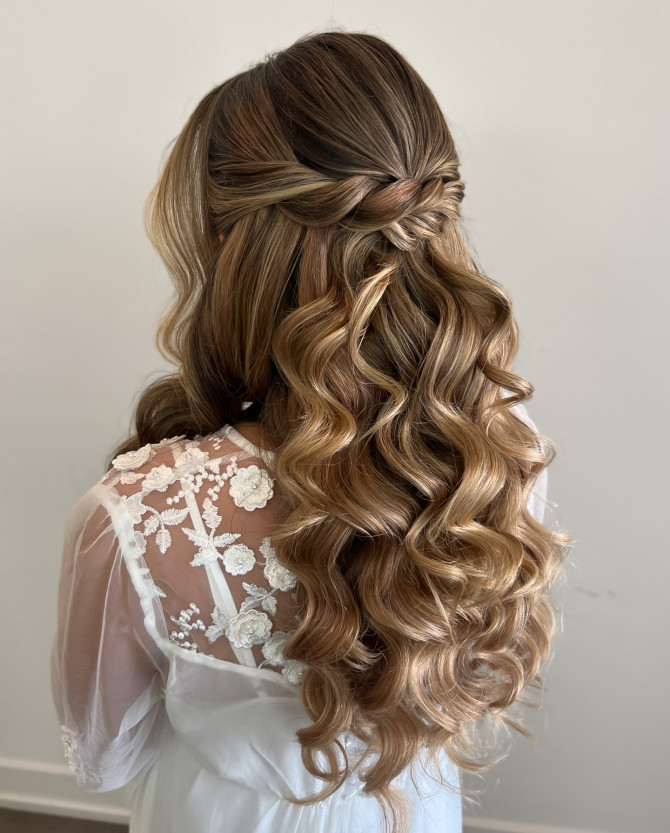 Twisted half-up bridal hairstyle with caramel blonde curls and boho lace gown by @erikataftbridal. Soft long waves bridal hairstyle for romantic wedding