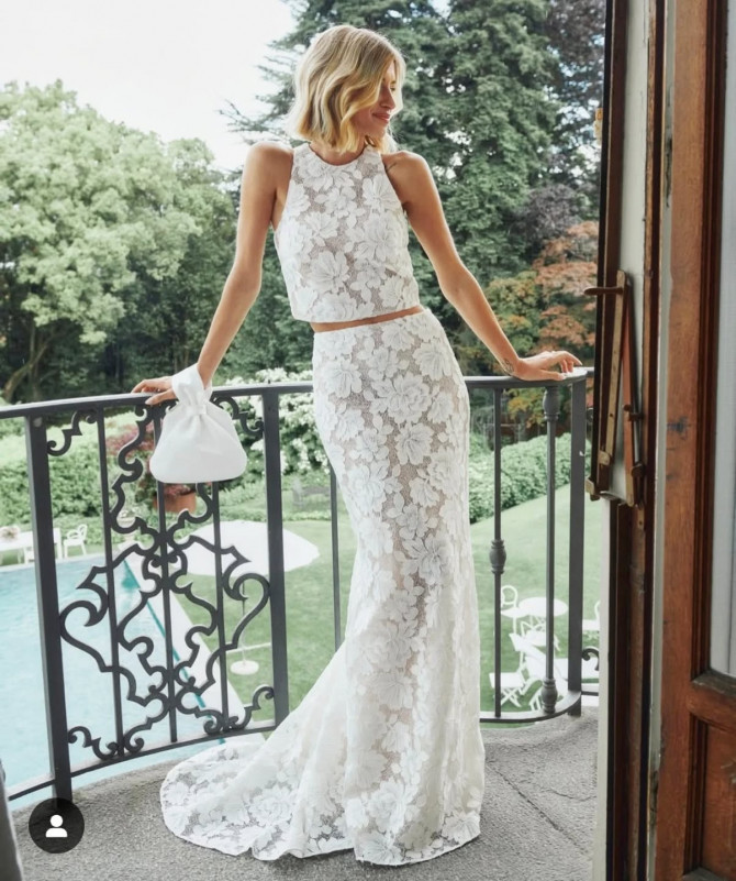Bride in low-back floral lace dress with train. boho lace gown