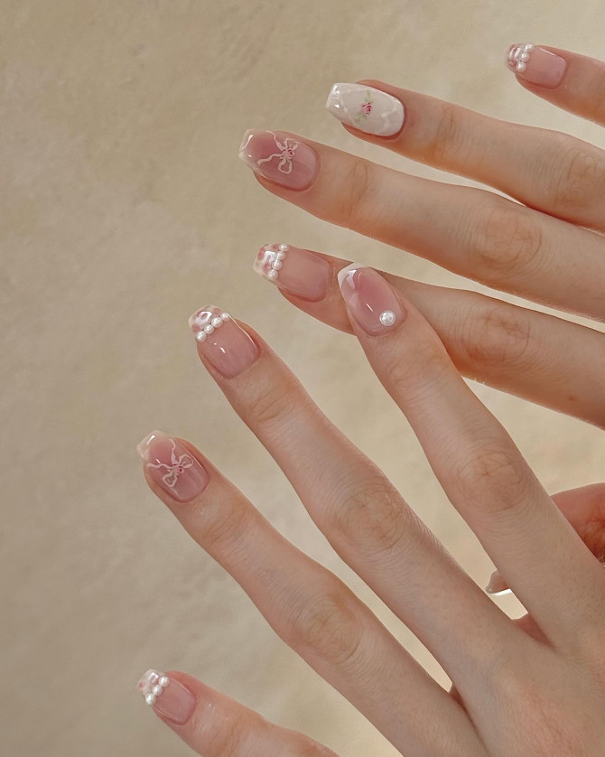 Soft pink base with pearls, white bows, and floral details.