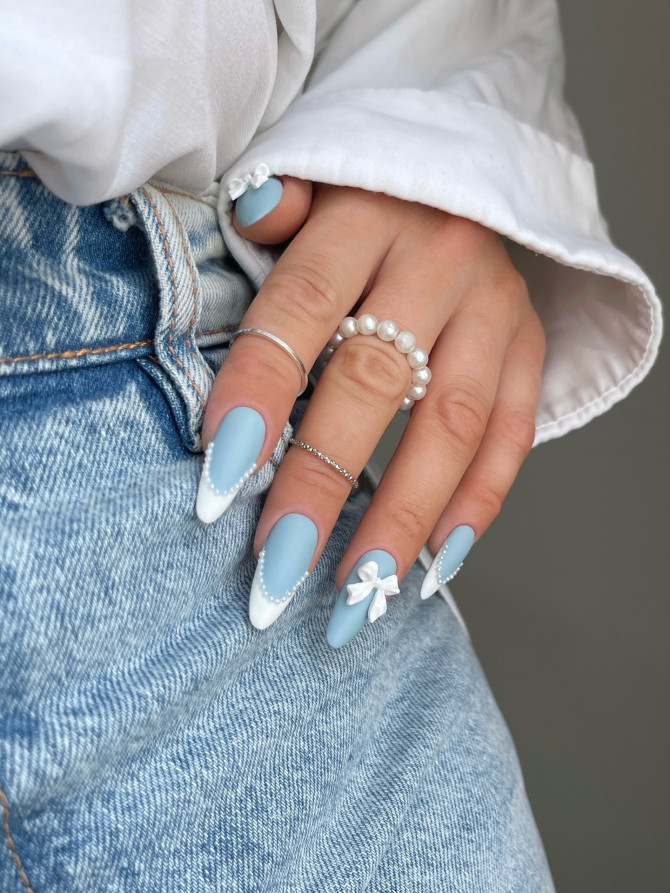 Baby blue matte acrylic nails with white 3D bow and pearl tips Minimalist Blue Nails with Pearl Bow Tips