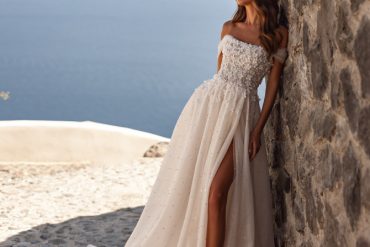Soft ivory A-line bridal gown with delicate lace bodice and flowing skirt. Timeless Bridal Gowns with lace details