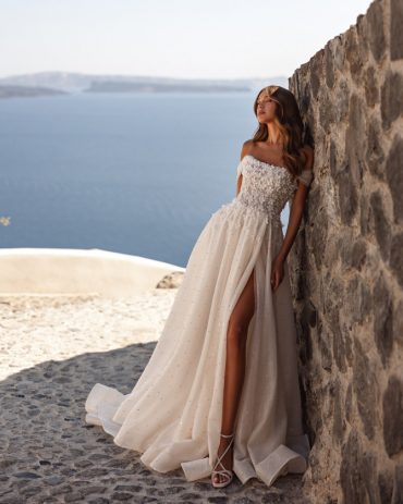Soft ivory A-line bridal gown with delicate lace bodice and flowing skirt. Timeless Bridal Gowns with lace details