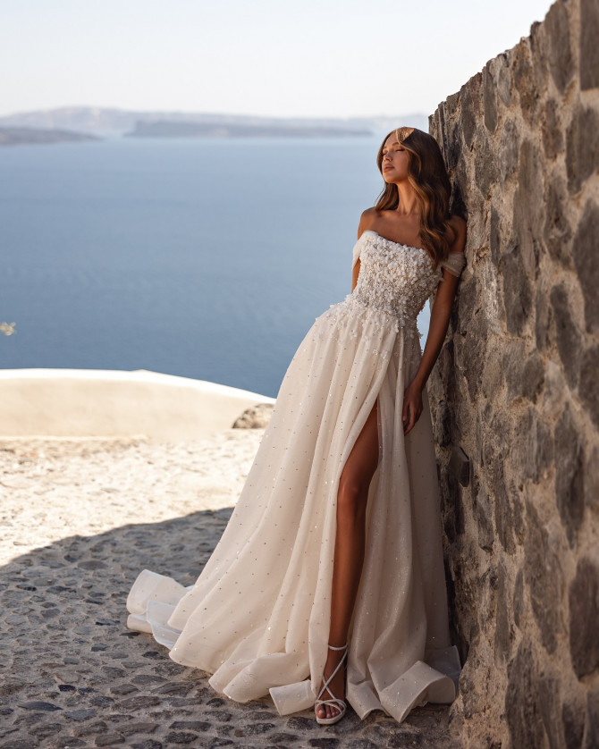 Soft ivory A-line bridal gown with delicate lace bodice and flowing skirt. Timeless Bridal Gowns with lace details