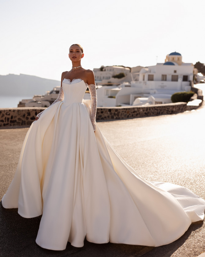 Off-shoulder lace wedding dress with soft tulle layers. Timeless Bridal Gowns with lace details