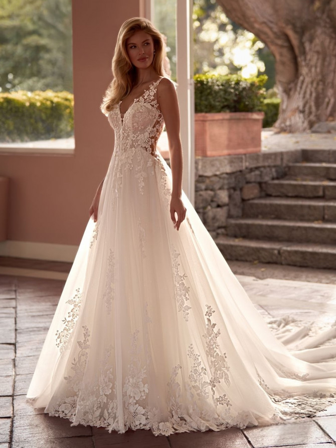 Modern white gown with thigh-high slit and clean lines. Elegant wedding gown from France