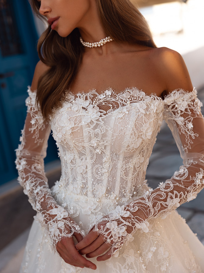 Light tulle bridal gown with delicate beading. Elegant wedding gown from France
