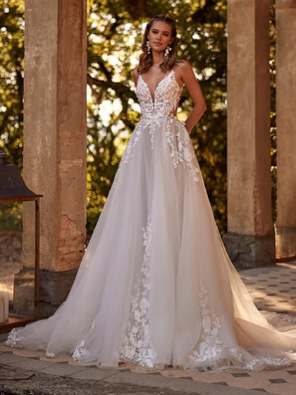 Lace-trimmed wedding gown with subtle shimmer. Elegant wedding gown from France