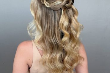 Braided crown half-up bridal style with soft waves.