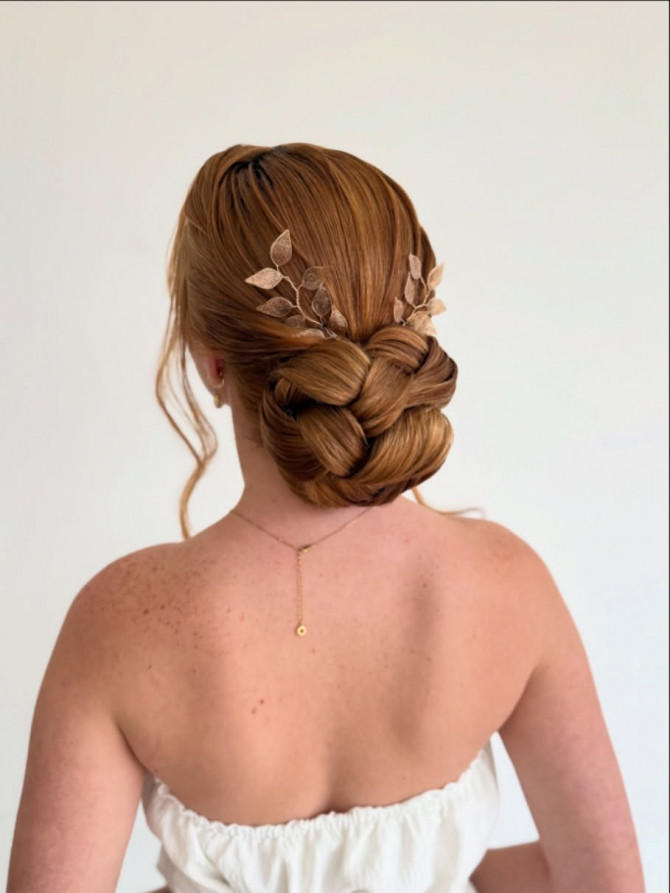 Low braided bun with leaf hair pins.