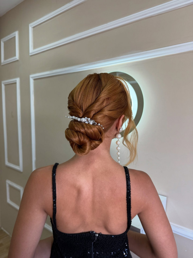 Sleek twisted low chignon with pearl barrette.