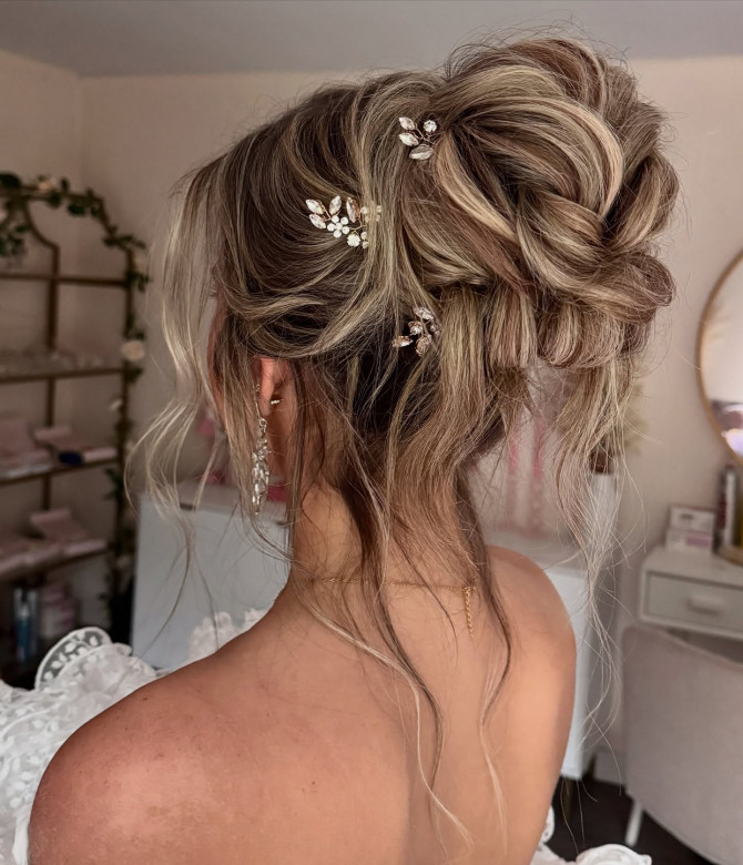 Elegant bridal updo with twisted volume and gold crystal hair accessories