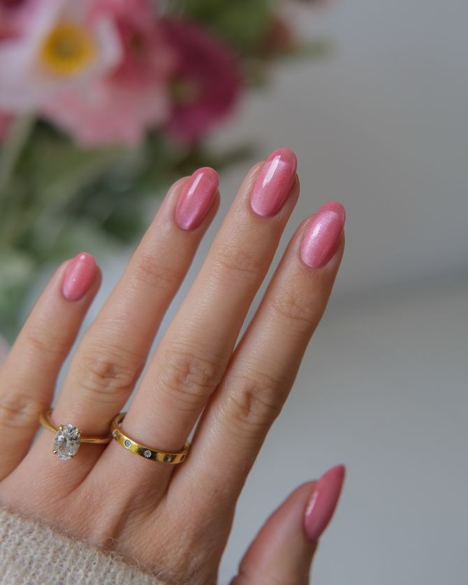 Pink almond nails with glossy shimmer finish, playful manicure for parties and summer