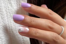 Glossy lavender short nails with white flower and crystal accent. Minimalist Blue Nails with Pearl Bow Tips