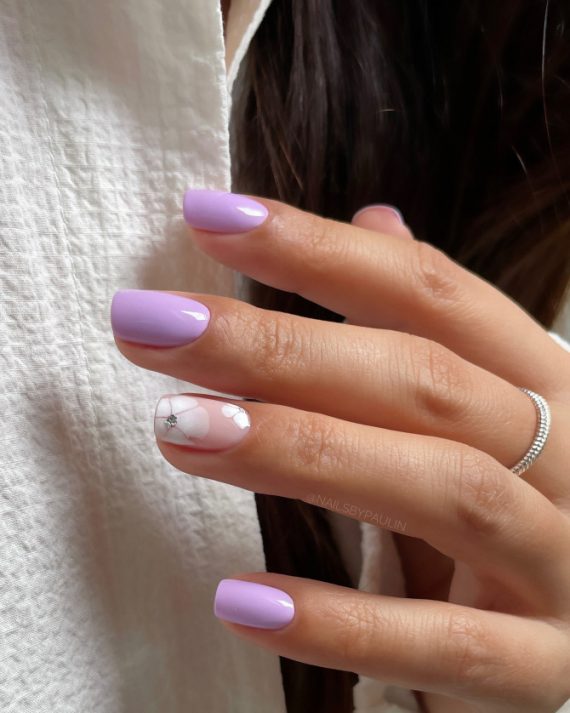 Glossy lavender short nails with white flower and crystal accent. Minimalist Blue Nails with Pearl Bow Tips