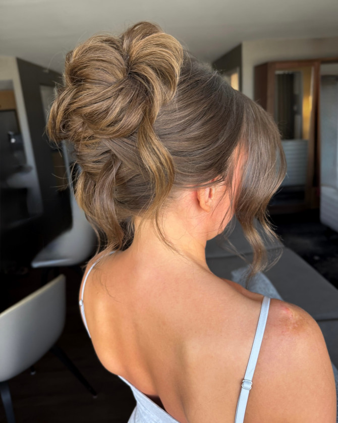 Modern bridal updo with structured waves and side-swept bangs