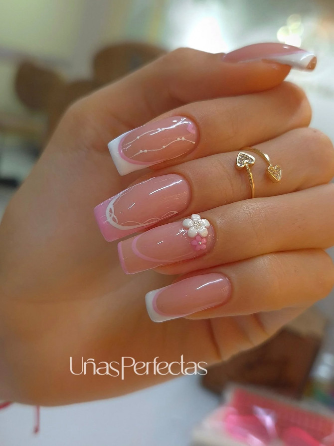 Pink French tip acrylic nails with white swirls and 3D flower on square shape