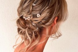 Romantic twisted bridal updo hairstyle with pearl accessories