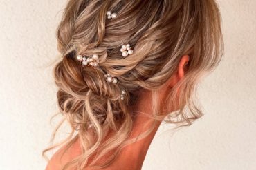 Romantic twisted bridal updo hairstyle with pearl accessories
