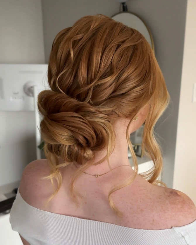 Soft twisted low bun bridal hairstyle with ginger hair