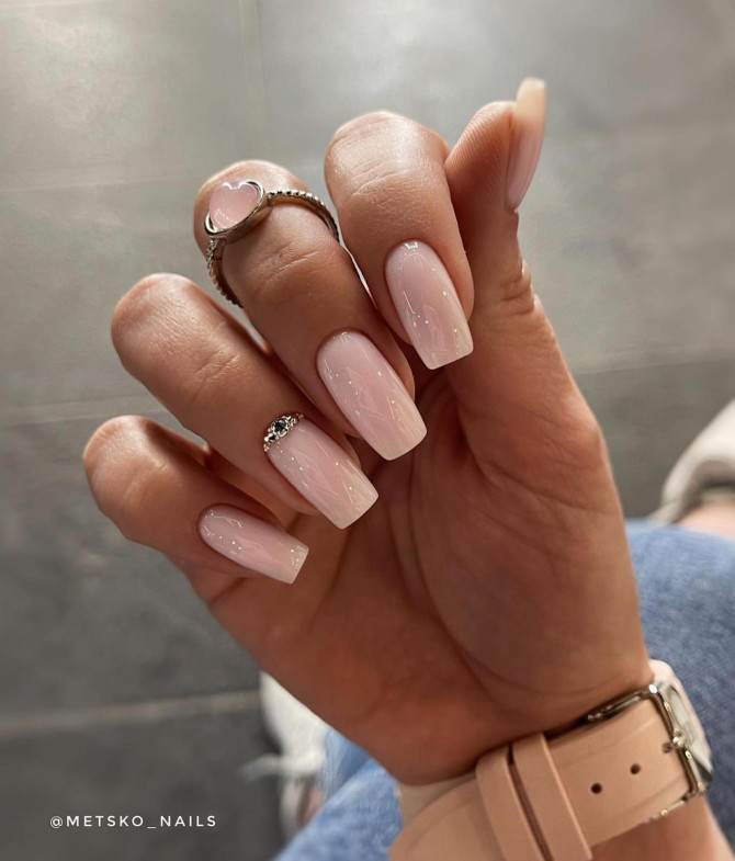 Minimal blush pink acrylic nails with crystal accent