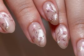 Nude acrylic nails with hand-painted sakura blossoms