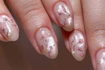 Nude acrylic nails with hand-painted sakura blossoms