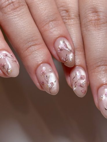 Nude acrylic nails with hand-painted sakura blossoms
