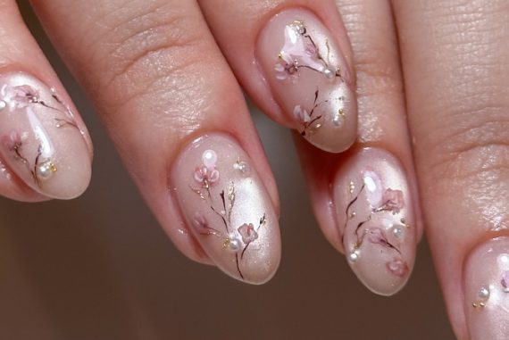 Nude acrylic nails with hand-painted sakura blossoms
